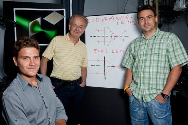 In 2012, the research demonstrated a prototype flat lens that could create a perfectly focused image or a twisting vortex beam. In a major leap forward, announced in February 2015, the researchers have demonstrated that a metasurface can focus different wavelengths of light at the same point, achieving instant color correction in one extremely thin, miniaturized device. Left to right: Francesco Aieta, Federico Capasso, and Patrice Genevet. Not pictured, Mikhail Kats. (File photo by Eliza Grinnell, Harvard SEAS.)